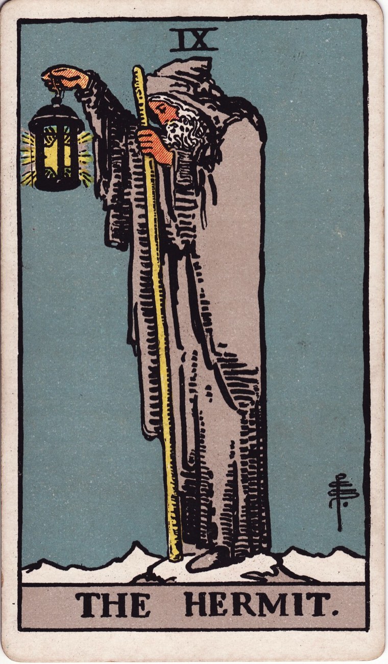 The Hermit in the Waite–Smith 1909 deck: solitary seeker, small guiding light, height or distance, staff or support