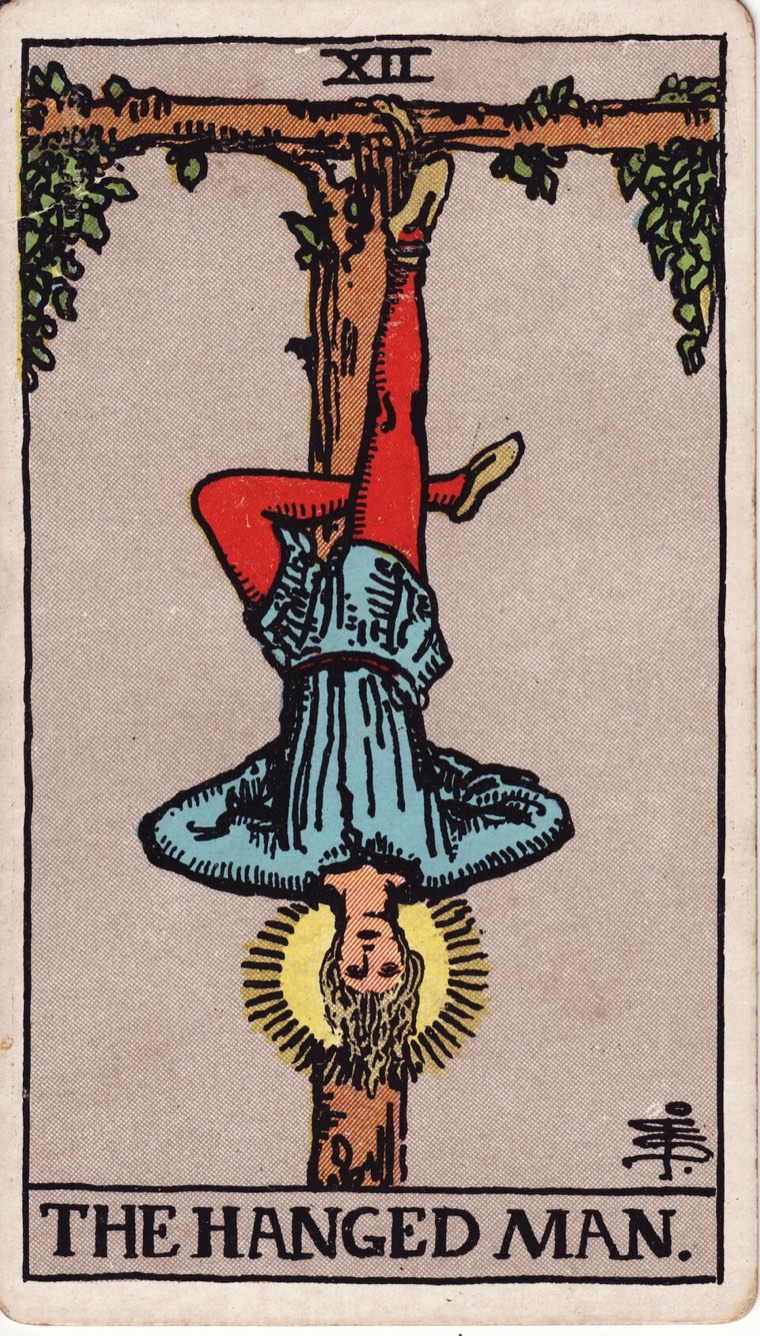 The Hanged Man in the Waite–Smith 1909 deck: voluntary suspension, inverted viewpoint, calm expression, one leg bent or other sign of chosen posture