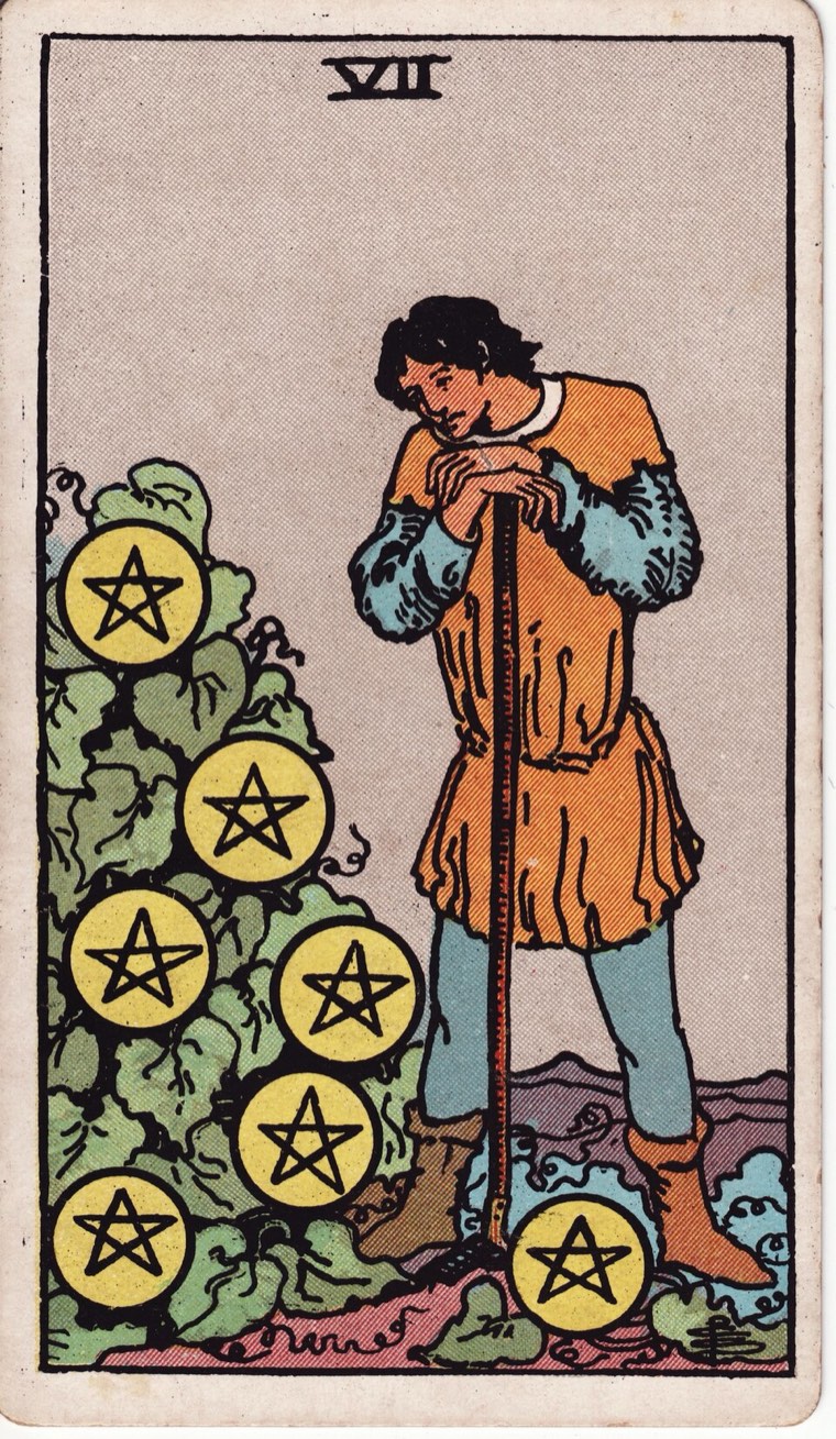 Seven of Pentacles in the Waite–Smith 1909 deck: worker contemplating cultivated growth, seven coins integrated with crop or project, rest after labor