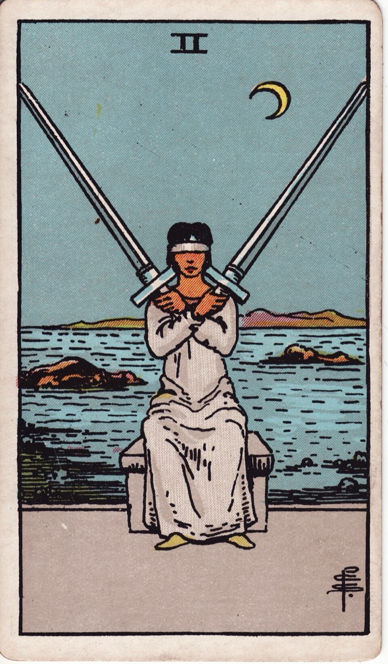 Two of Swords in the Waite–Smith 1909 deck: blindfolded or deliberately closed perception, two balanced crossed swords, water or emotion behind
