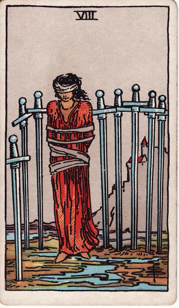 Eight of Swords in the Waite–Smith 1909 deck: loosely bound or restricted figure, eight surrounding swords, escape route visibly possible, limited vision