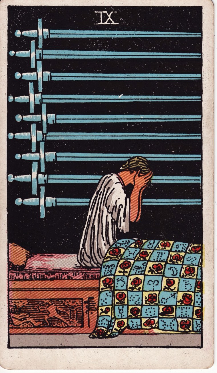 Nine of Swords in the Waite–Smith 1909 deck: waking distressed figure, night or private setting, nine swords arrayed behind or above