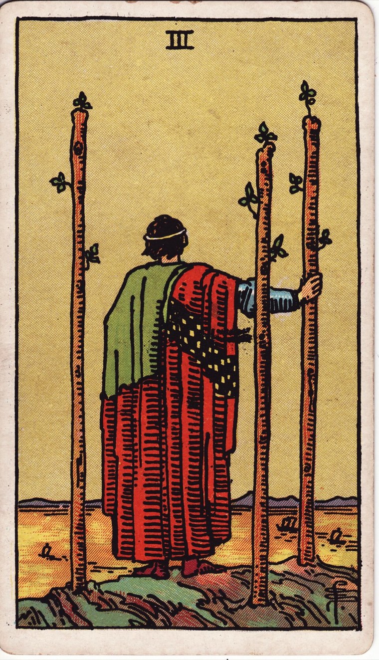 Three of Wands in the Waite–Smith 1909 deck: outward-looking figure, movement or ships at distance, established vantage