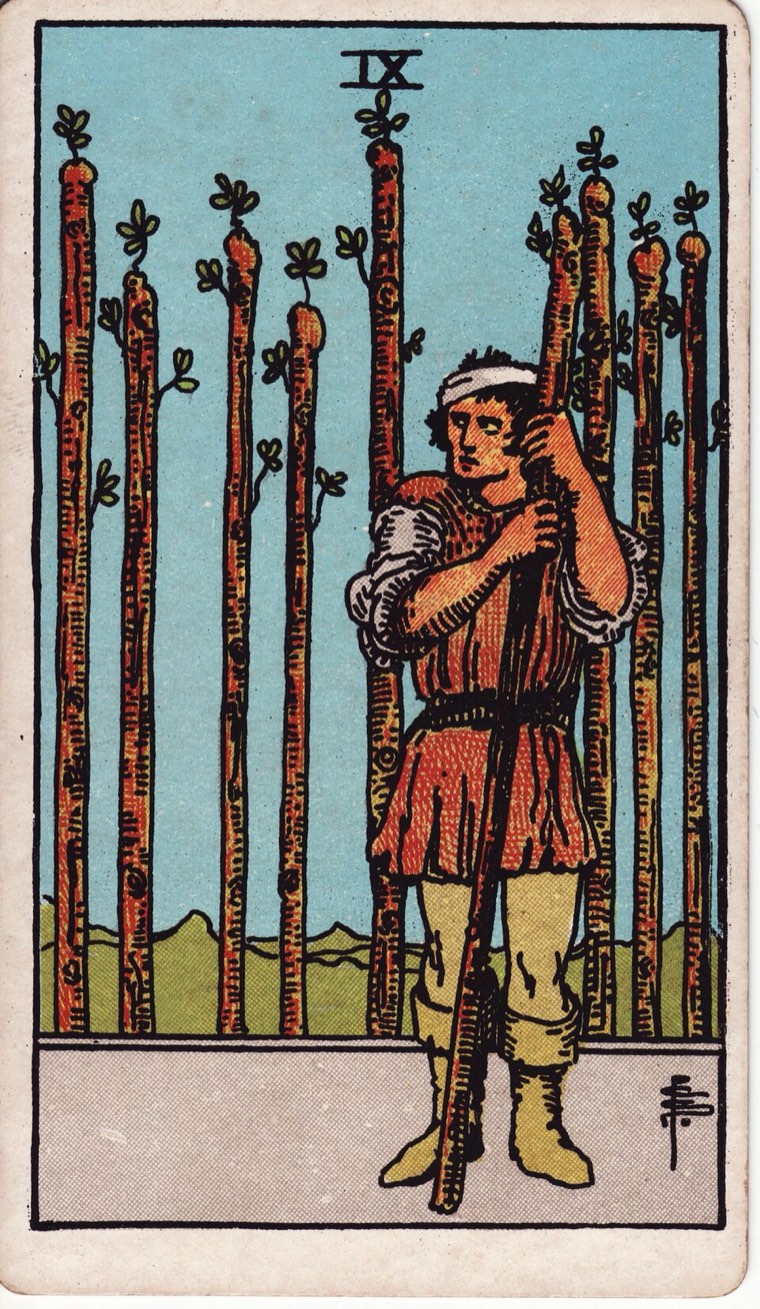Nine of Wands in the Waite–Smith 1909 deck: wounded or tired sentinel, defensive row, alert persistence